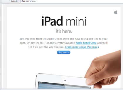 A screenshot of a webpage advertising an iPad mini, with a paragraph of indiscernible text above an image of a hand holding a white iPad by its corner.