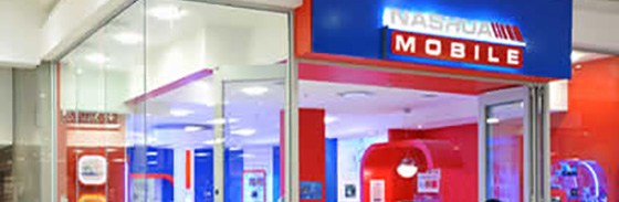 A Nashua Mobile storefront, with the walls painted red and blue and the logo over a glass folding door.