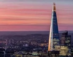 A beautiful pink sunset over a city skyline with modern skyscraper buildings.