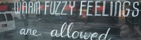A chalkboard with the text "WARM FUZZY FEELINGS are allowed".