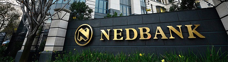 The gates outside of Nedbank, with the company logo written in gold on a black wall.