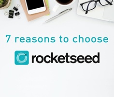 A birds-eye-view of a desk with various stationary and tech visible, with the words "7 reasons to choose" and the Rocketseed logo below.