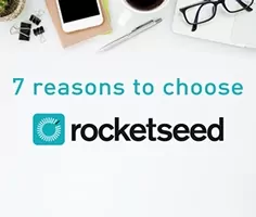 A birds-eye-view of a desk with various stationary and tech visible, with the words "7 reasons to choose" and the Rocketseed logo below.