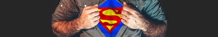 A torso shot of a man pulling open his shirt to reveal the Superman symbol.