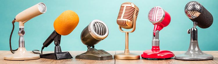 A row of six retro-looking microphones.