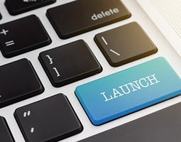 A close-up of a keypad, with one key highlighted in blue that reads "LAUNCH".