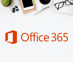 A birds-eye-view of a desk with various stationary and tech visible, with the Office 365 logo below.