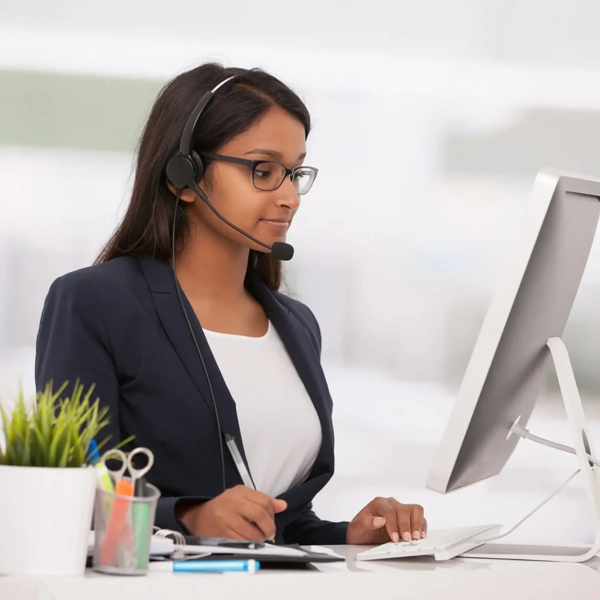 A customer support lady working behind her desk